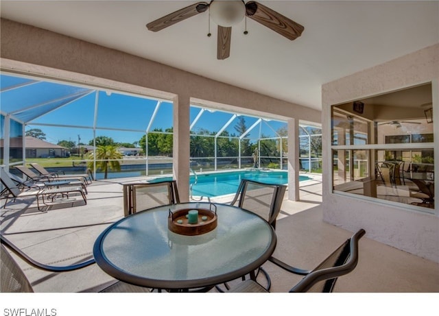 view of patio / terrace with ceiling fan and a lanai