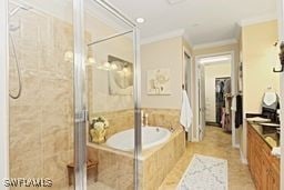 bathroom featuring shower with separate bathtub, vanity, and ornamental molding