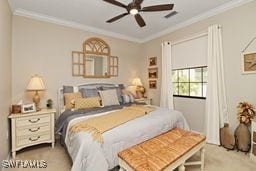 carpeted bedroom featuring ceiling fan and ornamental molding