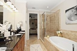 bathroom featuring separate shower and tub, crown molding, and vanity