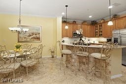 kitchen featuring a kitchen breakfast bar, hanging light fixtures, and stainless steel appliances