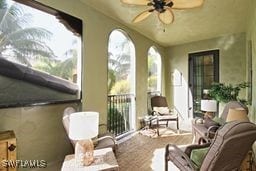 sunroom / solarium featuring ceiling fan