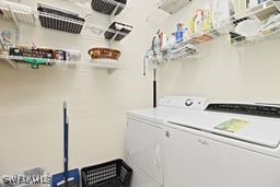 clothes washing area featuring washing machine and clothes dryer