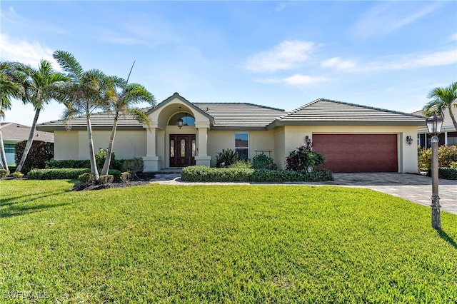 single story home featuring a front yard and a garage