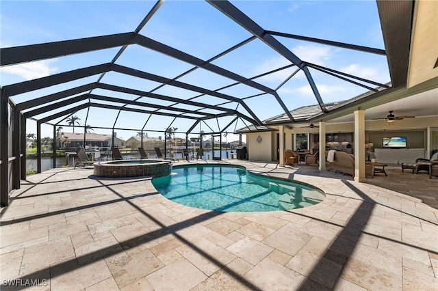 view of pool featuring an outdoor living space, ceiling fan, a water view, glass enclosure, and a patio area