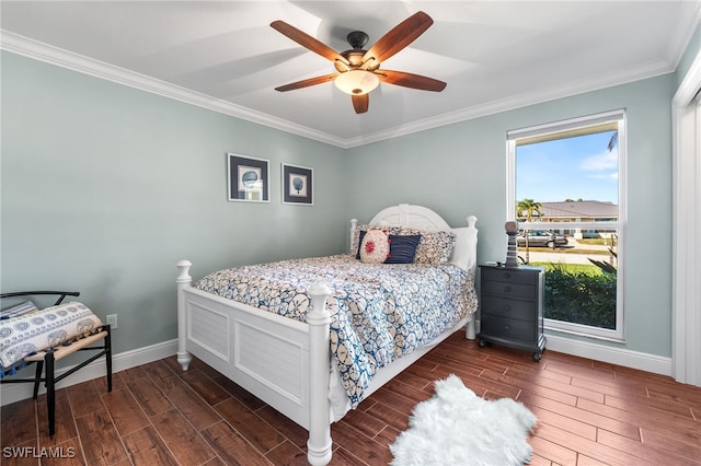 bedroom featuring ceiling fan, ornamental molding, and multiple windows