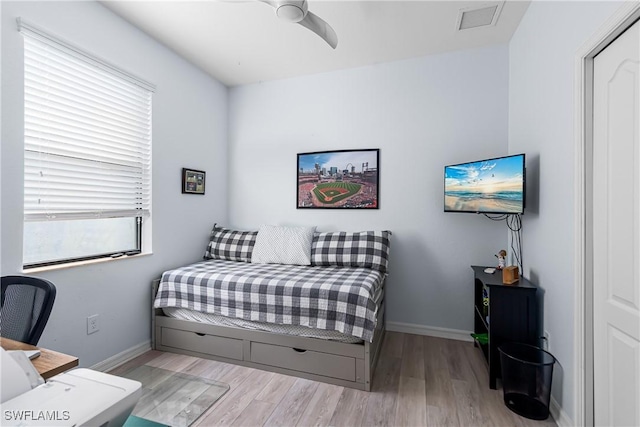 bedroom featuring light hardwood / wood-style floors and ceiling fan