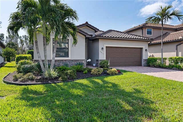 view of front of home with a garage and a front lawn