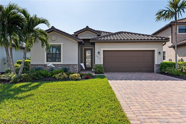 view of front of property with a garage and a front yard