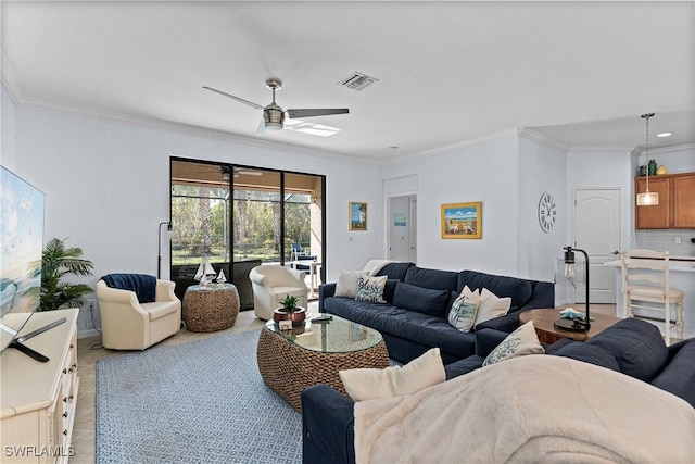 living room with crown molding and ceiling fan