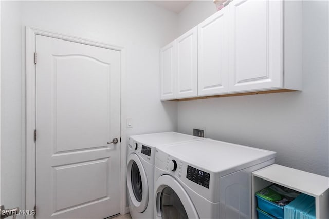 laundry room featuring independent washer and dryer and cabinets