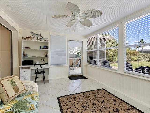 sunroom / solarium featuring ceiling fan