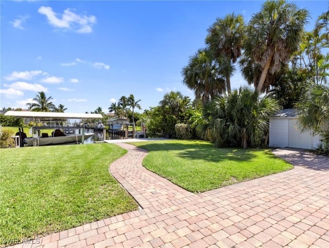 view of yard featuring a water view and an outdoor structure