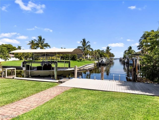 view of dock featuring a lawn and a water view