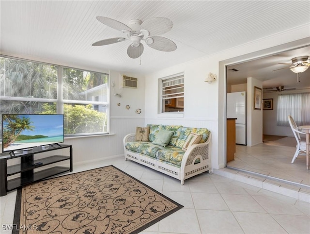 living room featuring ceiling fan, light tile patterned floors, and a wall mounted AC