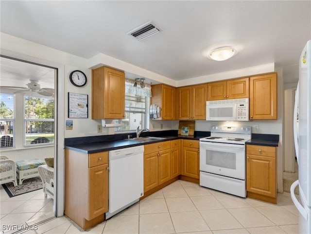 kitchen featuring light tile patterned flooring, white appliances, ceiling fan, and sink