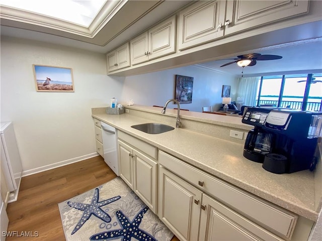 kitchen featuring white dishwasher, ceiling fan, crown molding, sink, and light hardwood / wood-style floors