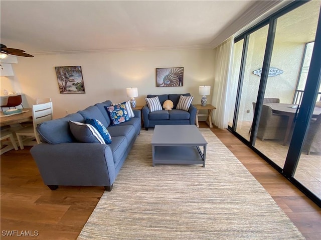 living room with ceiling fan, hardwood / wood-style floors, and ornamental molding