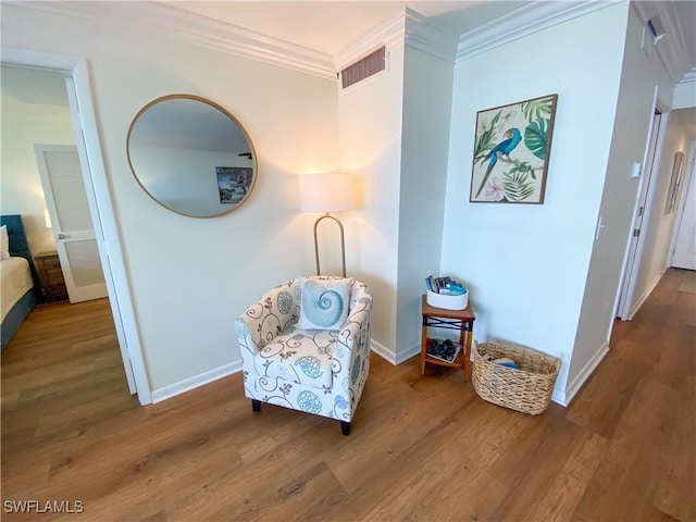 sitting room featuring dark hardwood / wood-style flooring and ornamental molding