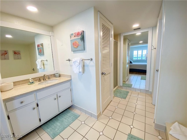 bathroom with tile patterned flooring and vanity