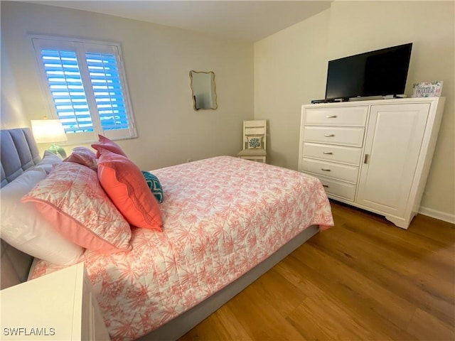 bedroom with hardwood / wood-style floors