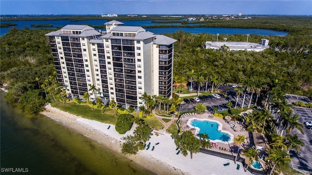 birds eye view of property with a beach view and a water view