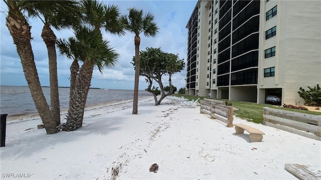 exterior space with a water view and a beach view