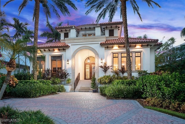 mediterranean / spanish-style home featuring a balcony