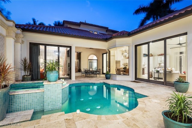 view of pool with a patio area and an in ground hot tub