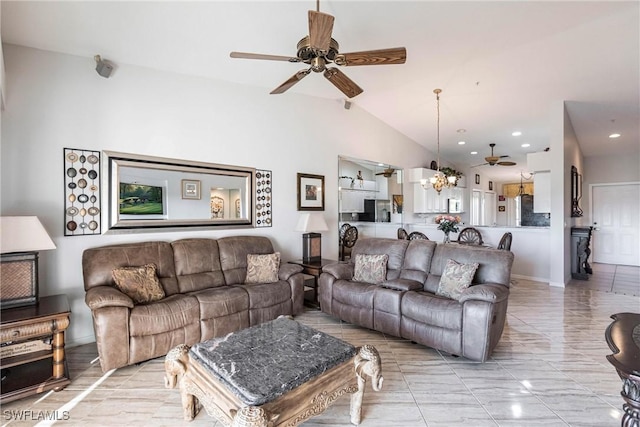 living room with ceiling fan with notable chandelier and vaulted ceiling