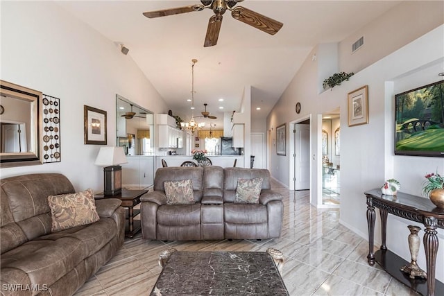 living room with ceiling fan and high vaulted ceiling