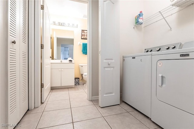 laundry area featuring light tile patterned floors and washer and dryer