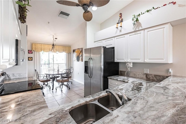 kitchen with sink, stainless steel fridge with ice dispenser, ceiling fan, light stone counters, and white cabinetry