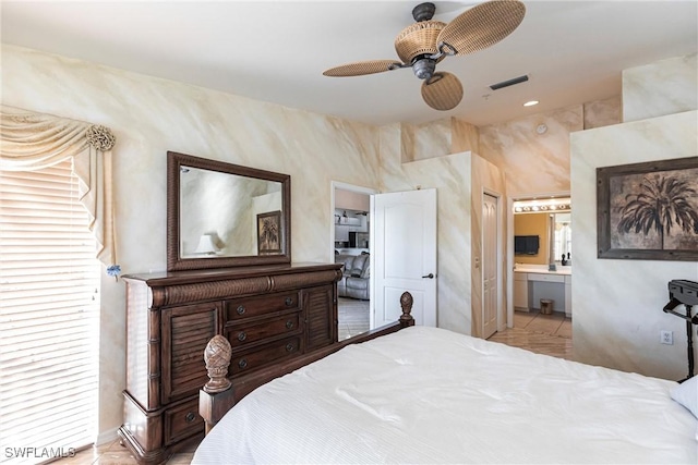 tiled bedroom with ceiling fan, a closet, and ensuite bath