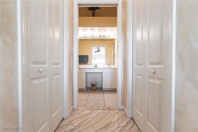 hall featuring light tile patterned floors