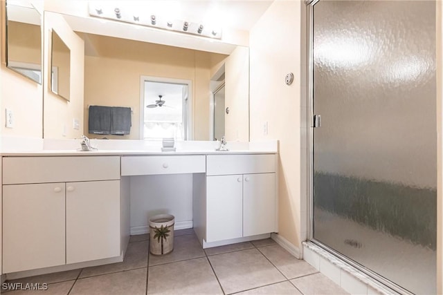 bathroom featuring tile patterned floors, ceiling fan, a shower with door, and vanity