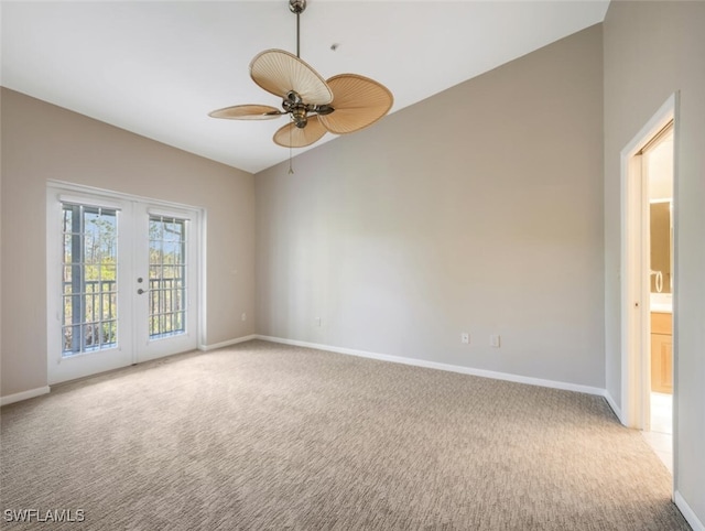 unfurnished room with ceiling fan, light colored carpet, french doors, and vaulted ceiling