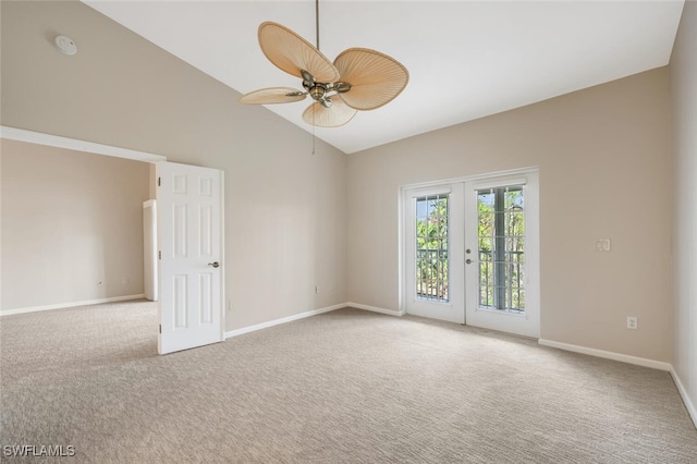 spare room with lofted ceiling, light colored carpet, french doors, and ceiling fan