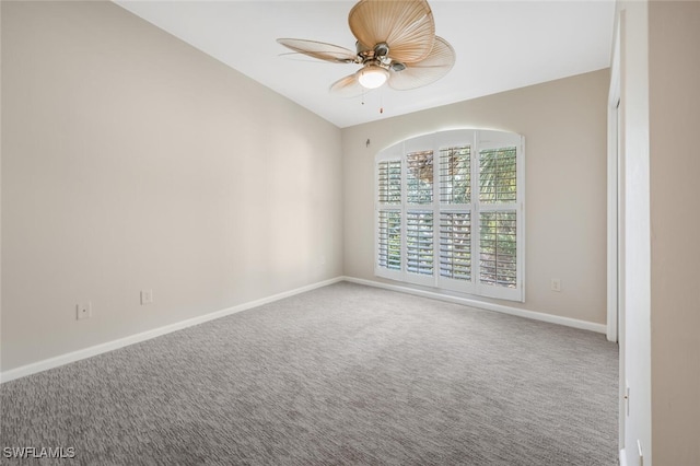 empty room with lofted ceiling, ceiling fan, and carpet