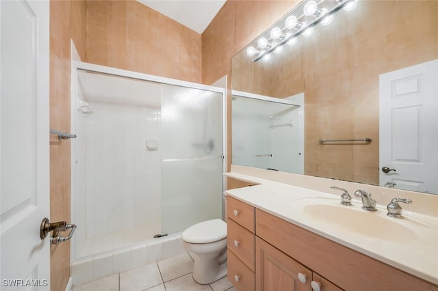 bathroom with toilet, vanity, a shower with shower door, and tile patterned floors