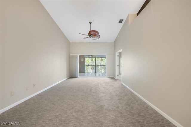 spare room featuring high vaulted ceiling, ceiling fan, and light colored carpet