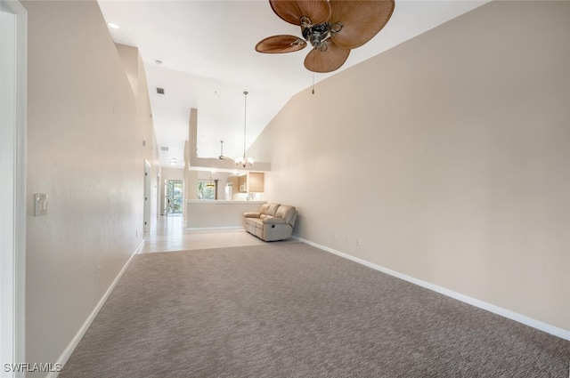 hallway featuring lofted ceiling, carpet flooring, and a notable chandelier