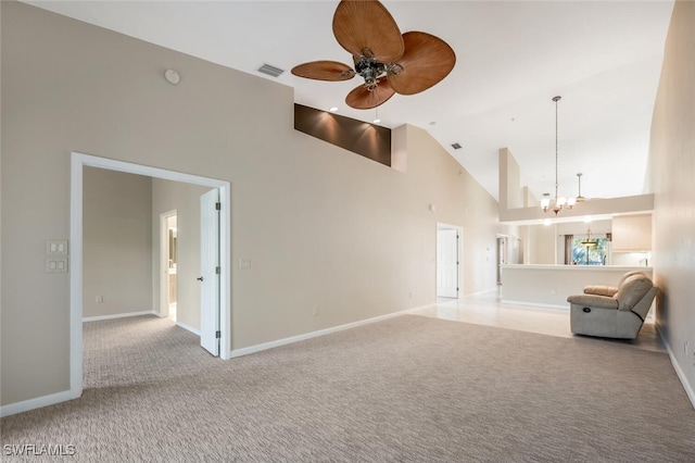 unfurnished living room with light carpet, high vaulted ceiling, and ceiling fan with notable chandelier