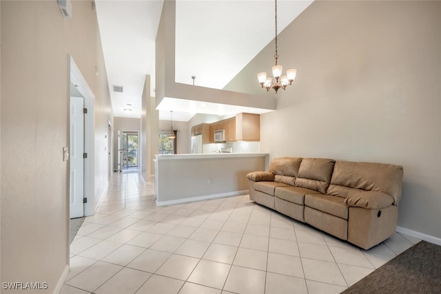 tiled living room featuring high vaulted ceiling and a notable chandelier