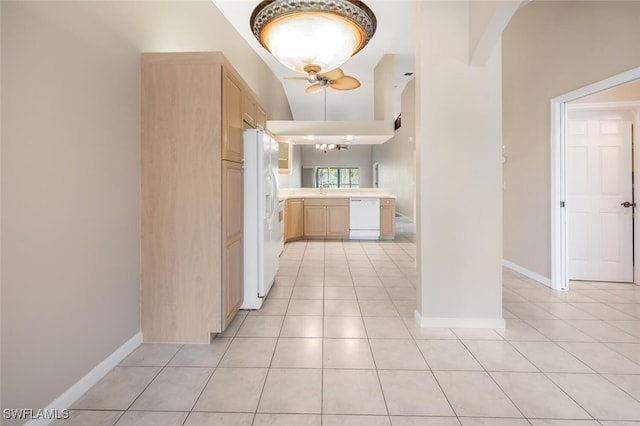 hall featuring lofted ceiling, light tile patterned floors, and sink