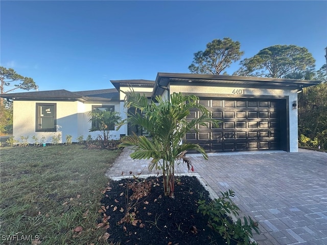 view of front of home with a front lawn and a garage