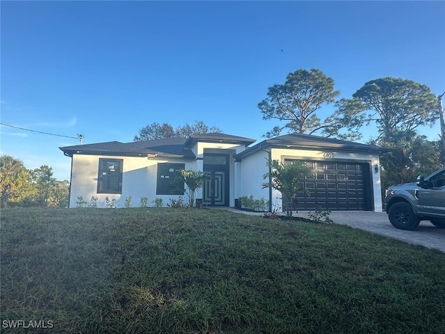 view of front of property with a front yard and a garage