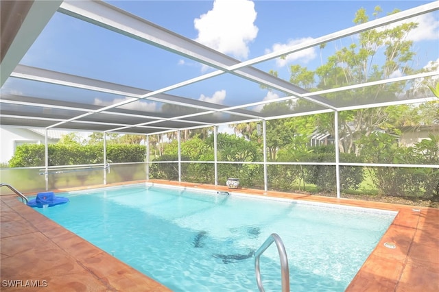 view of swimming pool with a lanai and a patio