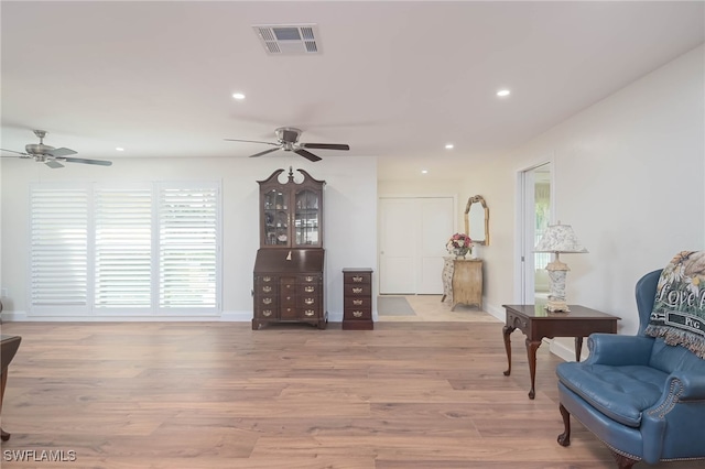 sitting room featuring light hardwood / wood-style flooring and ceiling fan