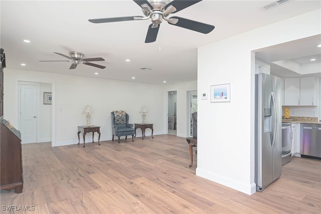 interior space featuring light hardwood / wood-style floors, white cabinetry, and stainless steel appliances